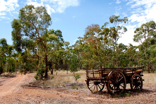 An abandoned wagon in the desert landscape of the Australian bush