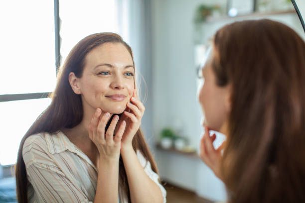 istock Young woman looking at a mirror at home 1493863482