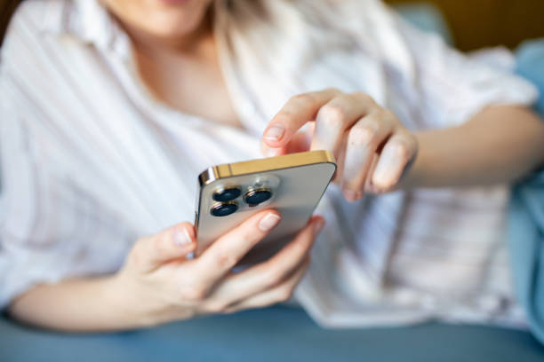 istock Young woman using a mobile phone at home 1493863624