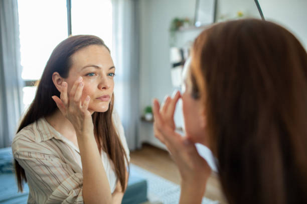 istock Young woman looking at a mirror at home 1493863626