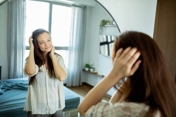 istock Young woman looking at a mirror at home 1493863657