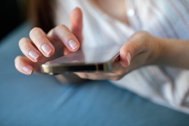 istock Young woman using a mobile phone at home 1493863736