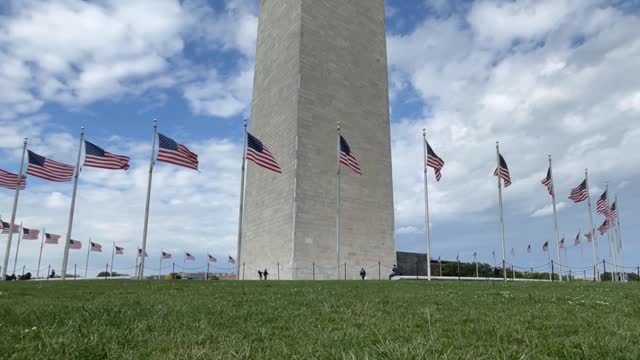 Washington Monument american flags blowing in the wind