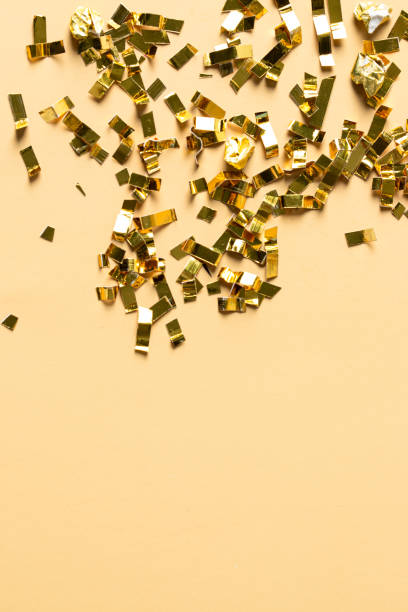 istock Gold sparkles particles on beige background. Holiday, wedding , cosmetic  backdrop. Copy space 1493864893