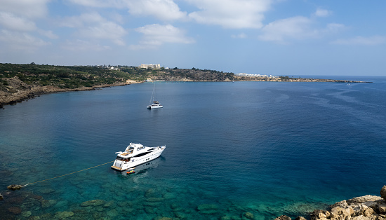 Drone aerial of tourist yachts with people sailing in the sea. Summer holidays in the ocean.