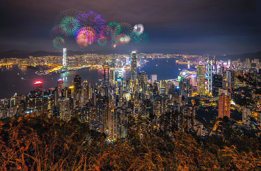 Japan. December 9, 2018 :  Scenic view at Night of Hong Kong Skyscraper Buildings around Victoria Harbor with Fireworks, Hong Kong