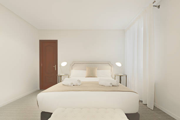 istock Plain light colored bedroom with large double bed in a vacation rental apartment 1493870872