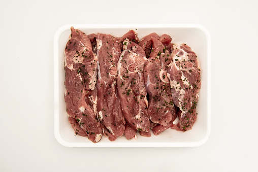 Raw turkey fillets chopped with bone and seasoned with parsley and garlic