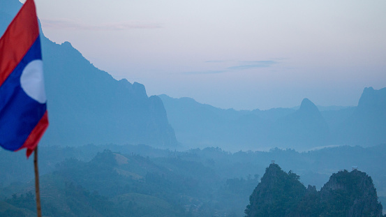 View on the mountains at sunrise, with a mysterious fog, in Vang Vieng, Laos.