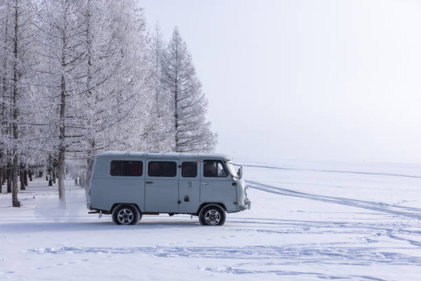 Car driving on an Icy Winter Road in Alaska’s  Arctic Wilderness