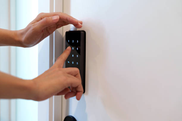 istock A woman is pressing a combination lock on a white wall while using her other hand to cover it, preventing people from seeing. 1493886941