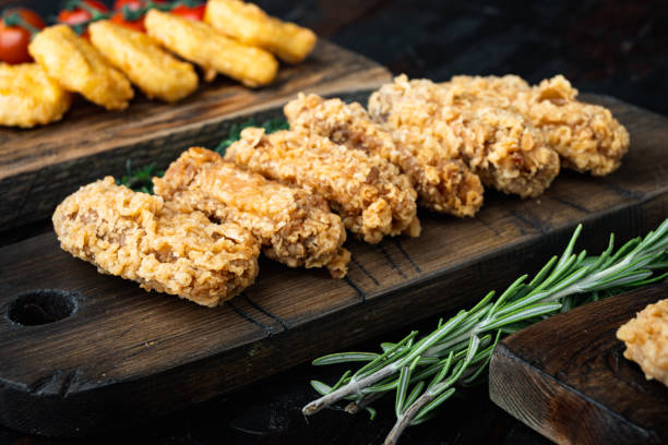 istock Crispy chicken tenders on dark wooden background 1493892667
