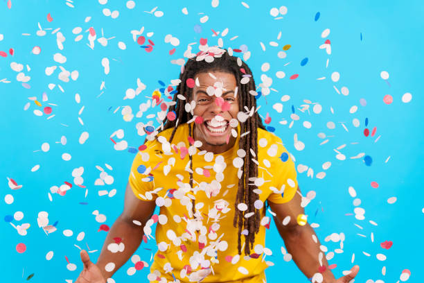 istock Happy latin man with dreadlocks surrounded by confetti in air 1493898196