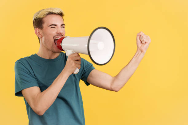 istock Angry gay man yelling using a loudspeaker 1493898226