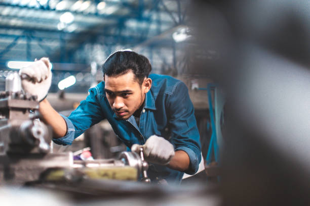 istock Factory young Asian working couple quality control, stand maintenance, talk in the Warehouse factory. Team Engineer Factory operator Operating meetings 1493899439