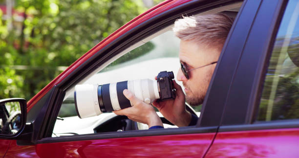 istock Private Spy In Car Taking Photos 1493900400