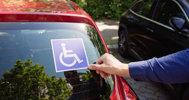 istock Driver Putting Wheelchair Sticker Sign 1493900419