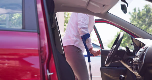 istock Young Man With Crutches Opening Door 1493900447