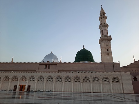 Beautiful morning view of Masjid Al Nabawi, Medina's green dome, minarets and mosque courtyard.