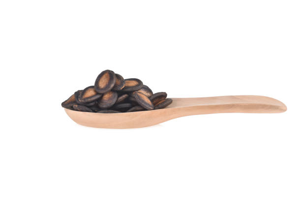 istock watermelon seed in wood spoon isolated on white background 1493913879
