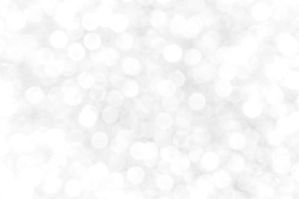 istock White and gray bokeh glitter sparking light background. 1493917031