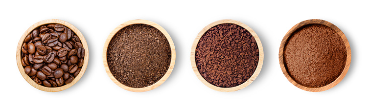 Roasted coffee beans and coffee powder (ground coffe) in wooden bowl isolated on white background. Top view. Flat lay