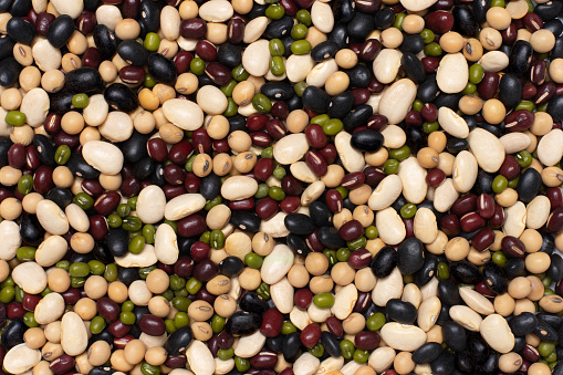 Mix organic beans with soybean, red beans, green mung bean and black gram bean texture background. Top view, flat lay.