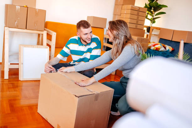 istock Young couple moving in new home packing boxes 1493920972