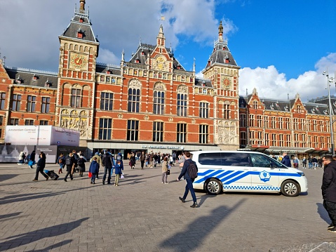 Amsterdam Centraal station is a major international railway hub, it is used by 192,000 passengers a day. Amsterdam Centraal was designed by Dutch architect Pierre Cuypers and opened in 1889. The image shows the main building captured during spring season.