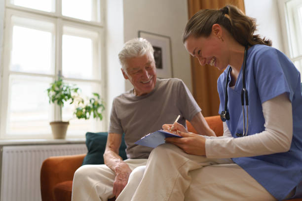 istock Young nurse checking elderly senior in his home. 1493925432