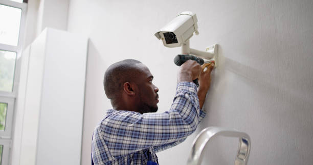 istock Close-up Of Technician Adjusting CCTV Camera 1493925525