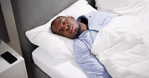 African American Man With Sleep Apnea Snoring