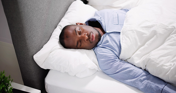 African American Man With Sleep Apnea Snoring