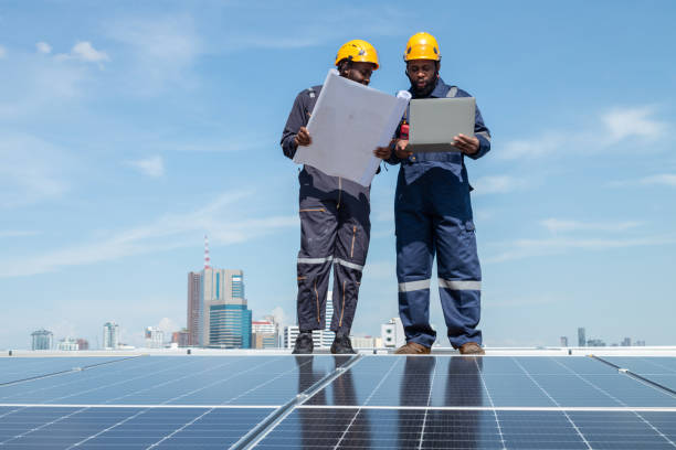 istock Engineers and technicians check drawings for installing solar cell panels on the roof. 1493926012