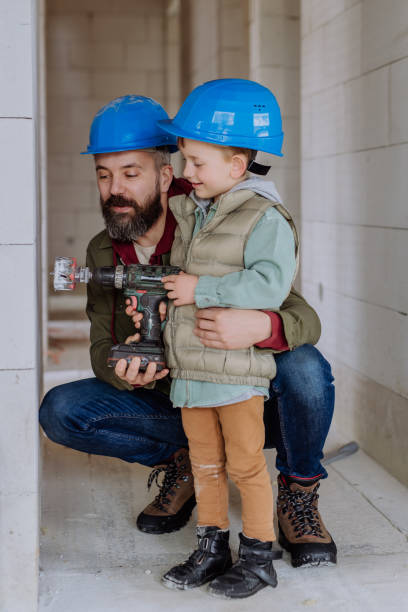 istock Father and his little son working on their unfinished house. 1493926051