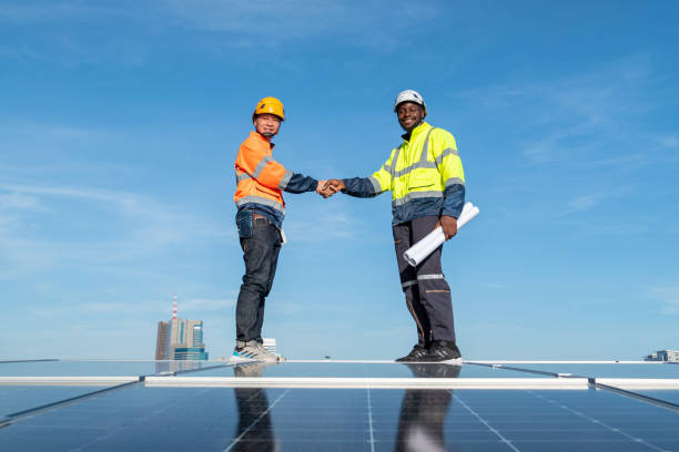 istock Engineers and technicians check drawings for installing solar cell panels on the roof. 1493929826