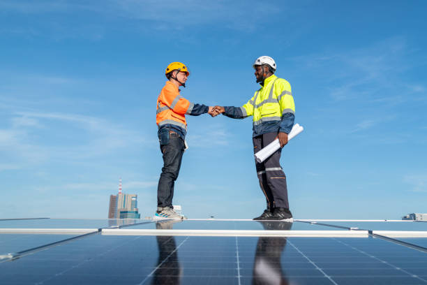 istock Engineers and technicians check drawings for installing solar cell panels on the roof. 1493929891