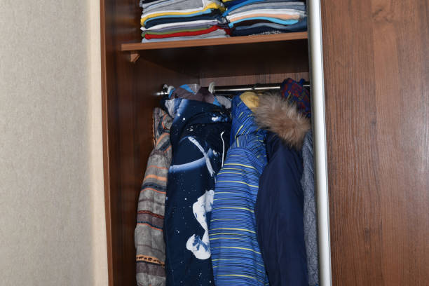 istock Wardrobe with clothes hanging on hangers. 1493931619