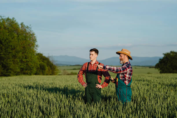 Smiling gay couple planting flowers in garden
