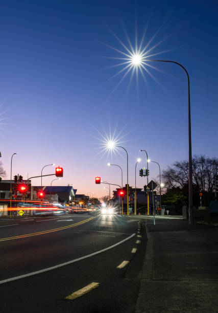 istock Car light trails at red traffic light on road intersection. Auckland. Vertical format. 1493933711