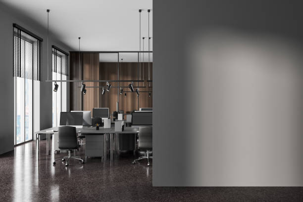 istock Gray and wooden open space office with mock up wall 1493935278