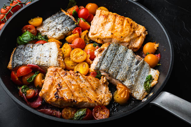 istock Smoky chorizosalmon grilled with cherry tomatoes on black background 1493935545