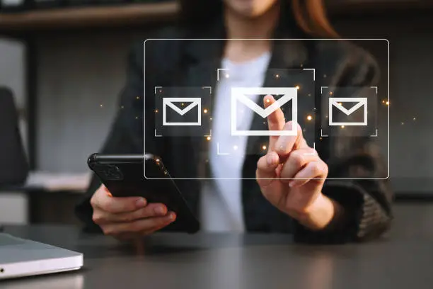 Photo of Woman hands using Laptop, tablet typing on keyboard and surfing the internet with email icon, email marketing concept, send e-mail or newsletter, online working internet network technology.