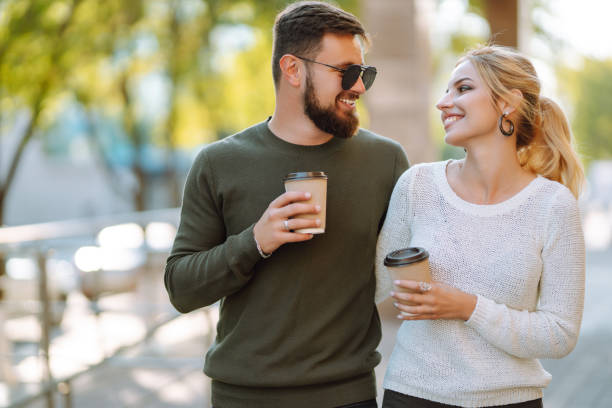 istock Stylish couple in love outdoors and drinking coffee. 1493936585
