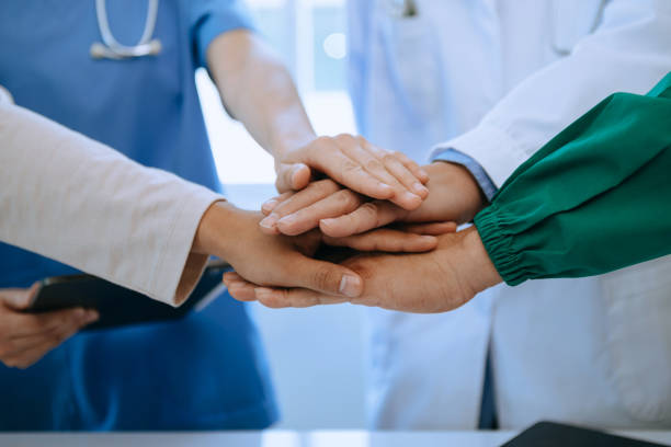istock Team Doctors nurses union coordinate hands Teamwork Concept in hospital for success and trust in the team. 1493936755