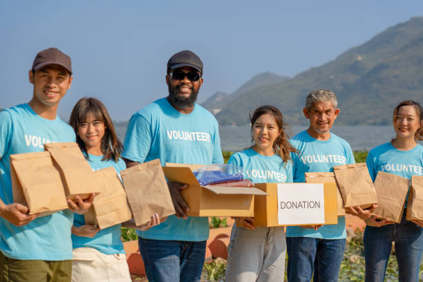 istock group volunteer carrying donation boxes raising money charitable working together 1493937286