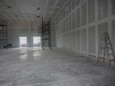 Interior construction work is in progress. connecting ceiling panels and wall panels