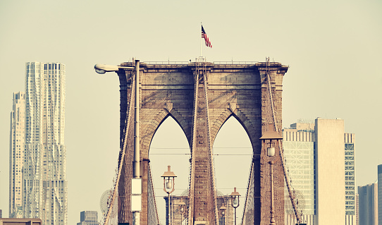 Retro toned picture of Brooklyn Bridge and Manhattan skyline, New York City, USA.