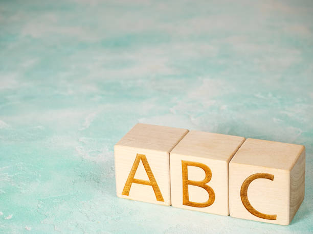 istock ABC text on wooden cubes on concrete background 1493940389