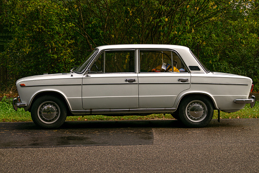 An old forty-year-old white car, historical Soviet heritage